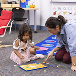 Ms. Noreen does a puzzle with a student