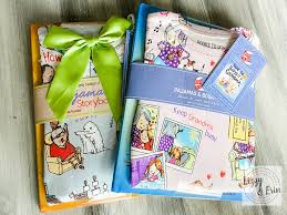 Two sets of children's pajamas wrapped in colorful packaging with ribbons, featuring playful designs and story themes.
